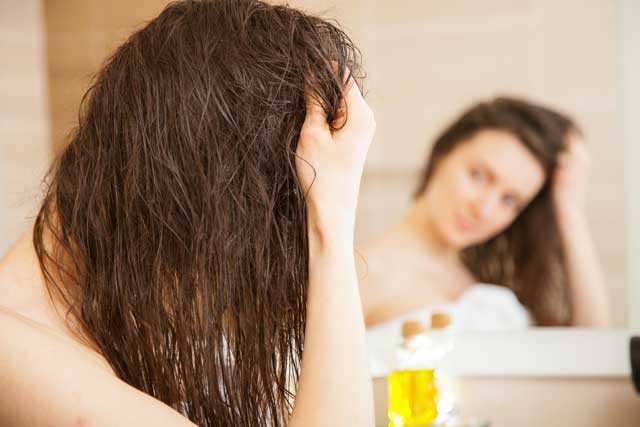 woman doing oil massage for Hair