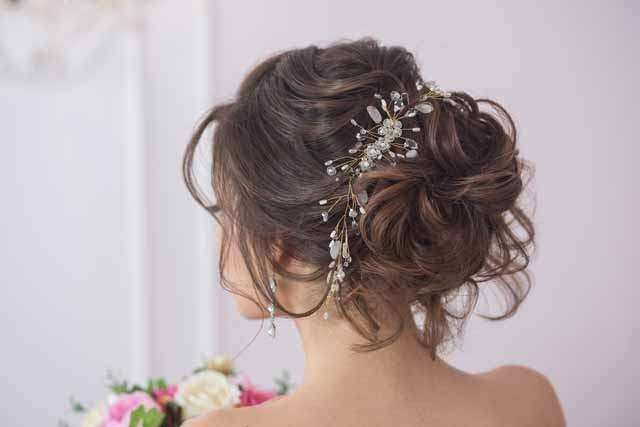 curl bun updo with silver flower pins for the Indian Bride | Photo Source -  Kim Jones Photography | Curated by Witty Vows - Witty Vows