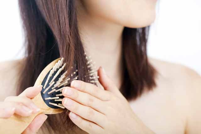 woman-combing-hair-in