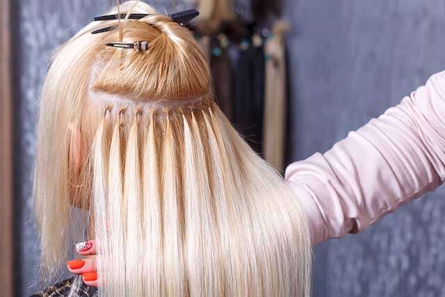 Premium Photo  Hair extension process of a young woman in a beauty salon  closeup