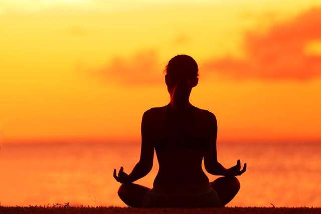 Woman doing yoga on sunset background - Stock Image - Everypixel