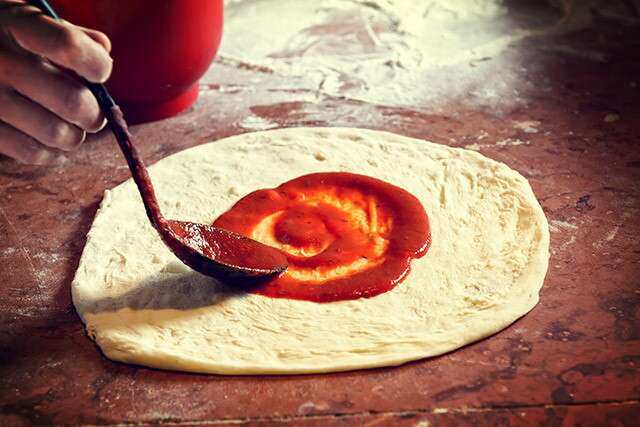Apply Tomato Sauce On Homemade Pizza Dough
