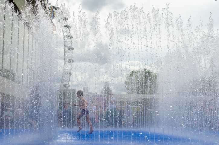 travel in a heat wave - boy in fountain
