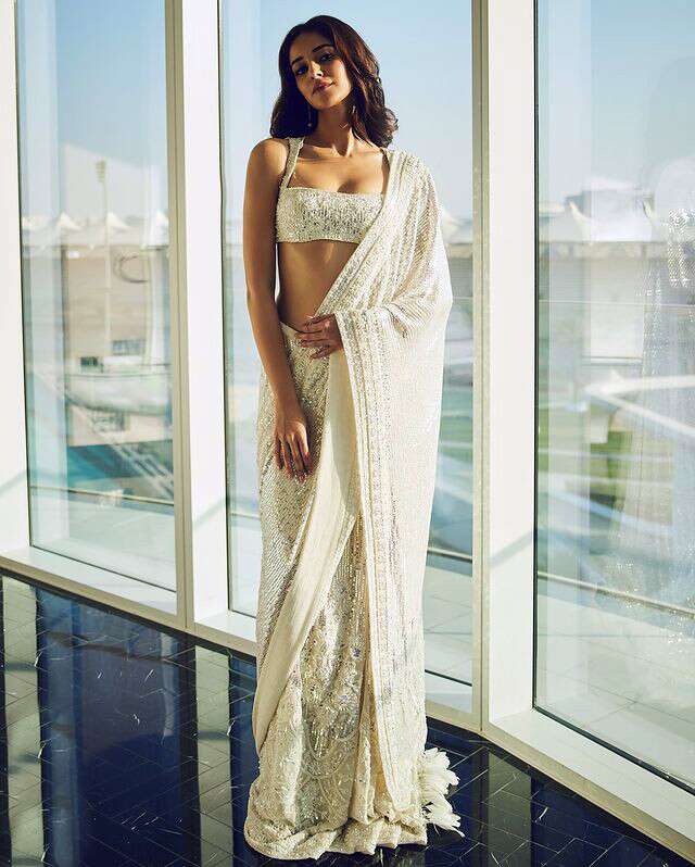 White cocktail sari for wedding party outfits.