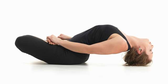 Supported Supta Sukhasana or Reclining Easy Cross-Legged Yoga for Heartburn