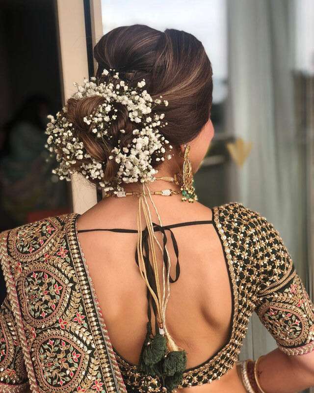 Traditional Buns With Real Flowers Hairstyles For Indian Brides