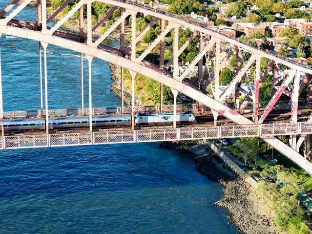 Amtrak has special Night Owl fares - Amtrak train crossing the Hell Gate Bridge in New York City