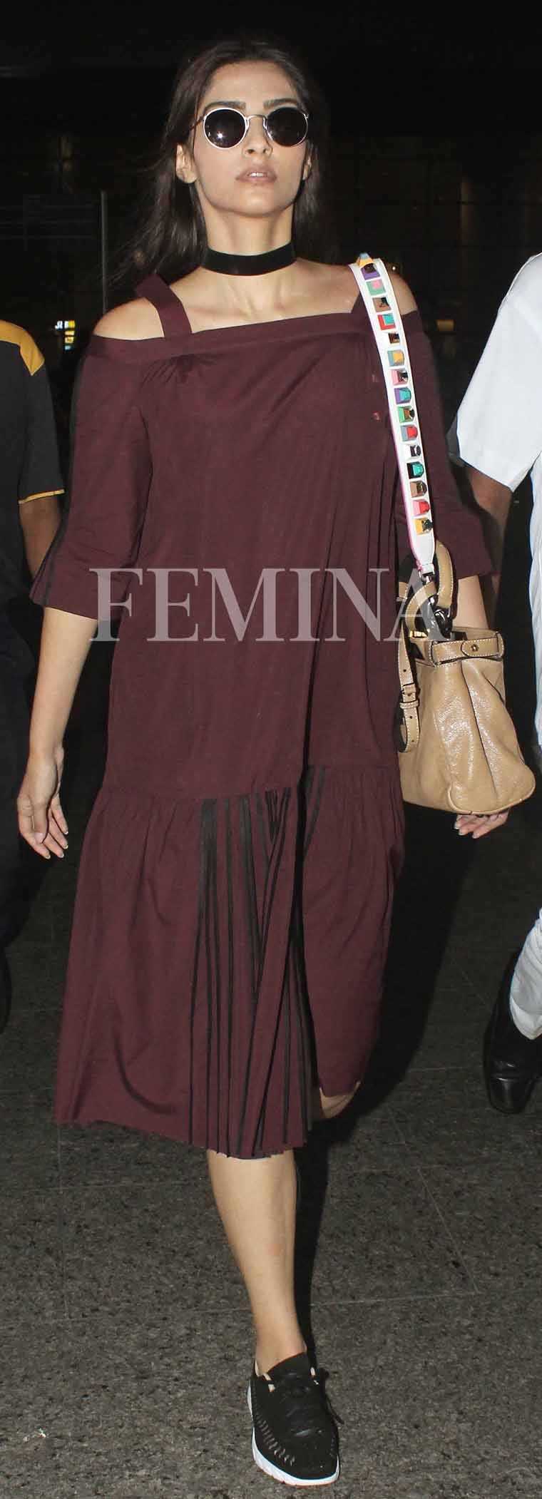 Sonam Kapoor chose a drop-waist Bodice dress in a deep maroon (the colour-of-the-moment). She accessorised with a Fendi sling (complete with the popular embellished guitar strap) and a pair of Nike sneakers.