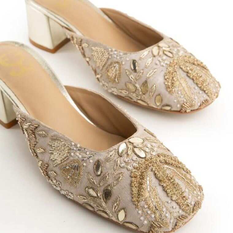 Payal Singhal x Fizzy Goblet White Lotus ivory heels featuring gold leaves, 3D motifs and shimmering festive embellishments