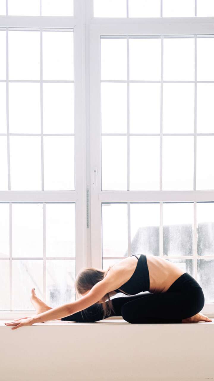 7 Calming Yoga Poses You Can Do From Your Bed